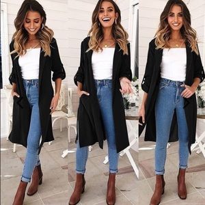 Black, knee length slit coat